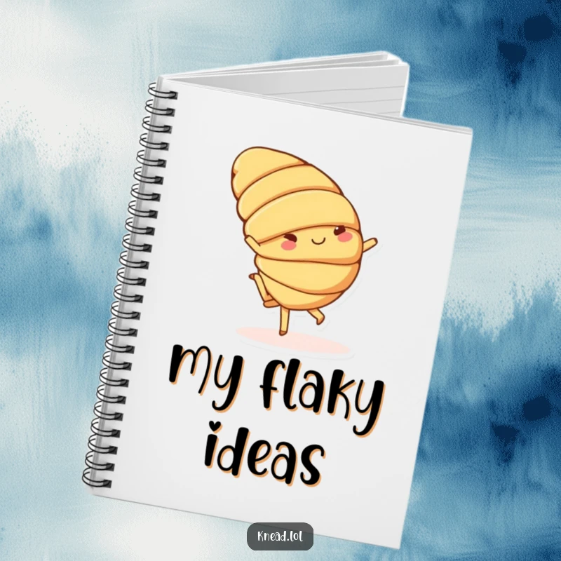 Funny notebook with a cheerful croissant character doing a playful cartwheel on the cover, ideal for creative thoughts.